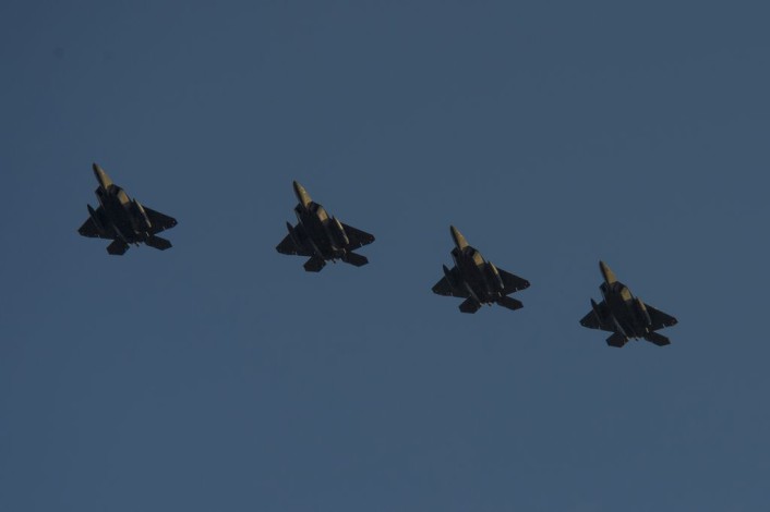Four F-22 Raptor fighter aircraft assigned to the 95th Fighter Squadron at Tyndall Air Force Base, Fla., fly over the runway before landing at Spangdahlem Air Base, Germany, Aug. 28, 2015. The U.S. Air Force deployed four F-22s, one C-17 Globemaster III and more than 50 Airmen to Spangdahlem in support of the first F-22 European training deployment. The inaugural F-22 training deployment to Europe is funded by the European Reassurance Initiative, a $1 billion pledge announced by President Obama in March 2014. (U.S. Air Force photo by Airman 1st Class Luke Kitterman/Released)