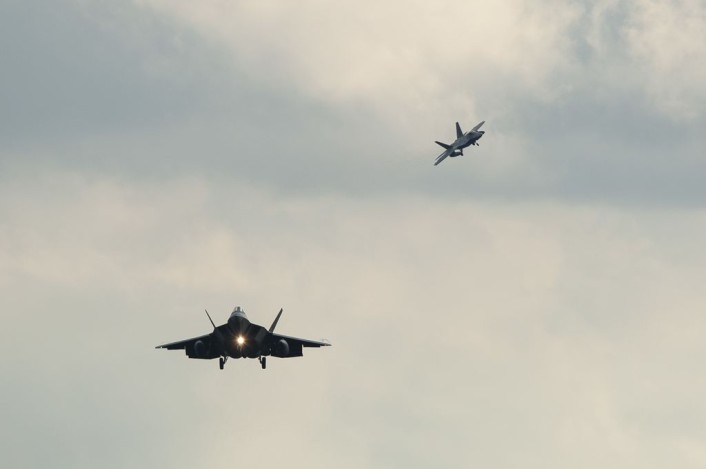 Two F-22 Raptor fighter aircraft prepare to land at Spangdahlem Air Base, Germany, Aug. 28, 2015, as part of the inaugural F-22 training deployment to Europe. Four F-22s from the 95th Fighter Squadron at Tyndall Air Force Base, Fla., along with a C-17 Globemaster III cargo aircraft and more than 50 support Airmen were part of the deployment. This effort is part of the European Reassurance Initiative and will serve to assure allies of the Air Force’s commitment to European security and stability. (U.S. Air Force photo by Staff Sgt. Chad Warren/Released)