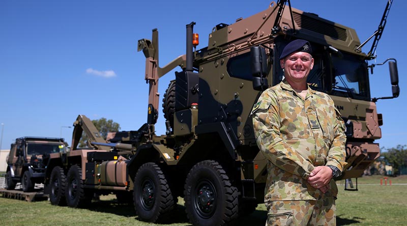 Australian Army soldier Corporal Grant Solomon, of the Land 121 Driver Training Team, stands in front on a new Rheinmetall MAN truck following the vehicle’s acceptance under LAND 121 Phase 3B at Gallipoli Barracks, Enoggera, Queensland.