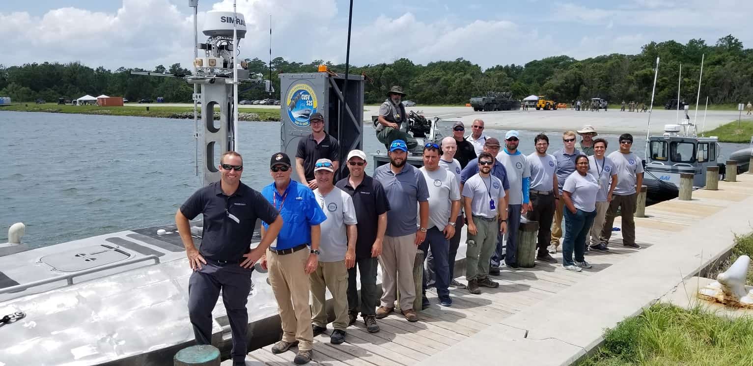 The Navy-industry Cooperative Research and Development Agreement (CRADA) team that developed the Expeditionary Warfare Unmanned Surface Vessel (USV) is pictured at the 2019 Advanced Naval Technology Exercise (ANTX).